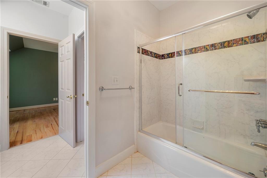 5360 Northwater Way Duluth, GA 30097 - Photo 31 of 62 a bathroom with a shower and a bath tub