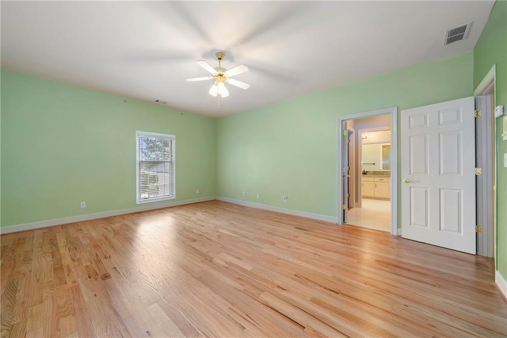 5360 Northwater Way Duluth, GA 30097 - Photo 36 of 62 a view of an empty room with wooden floor and a ceiling fan