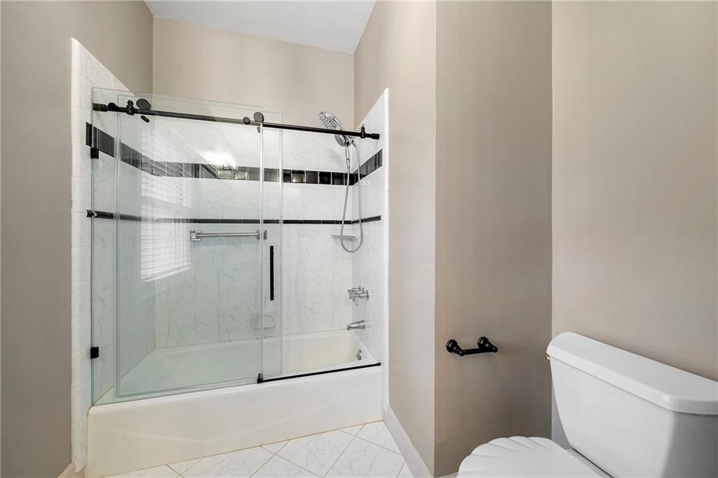 5360 Northwater Way Duluth, GA 30097 - Photo 37 of 62 a bathroom with a glass shower door