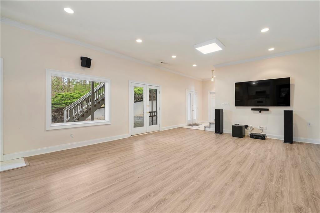 5360 Northwater Way Duluth, GA 30097 - Photo 40 of 62 a view of a livingroom with a flat screen tv wooden floor and a window