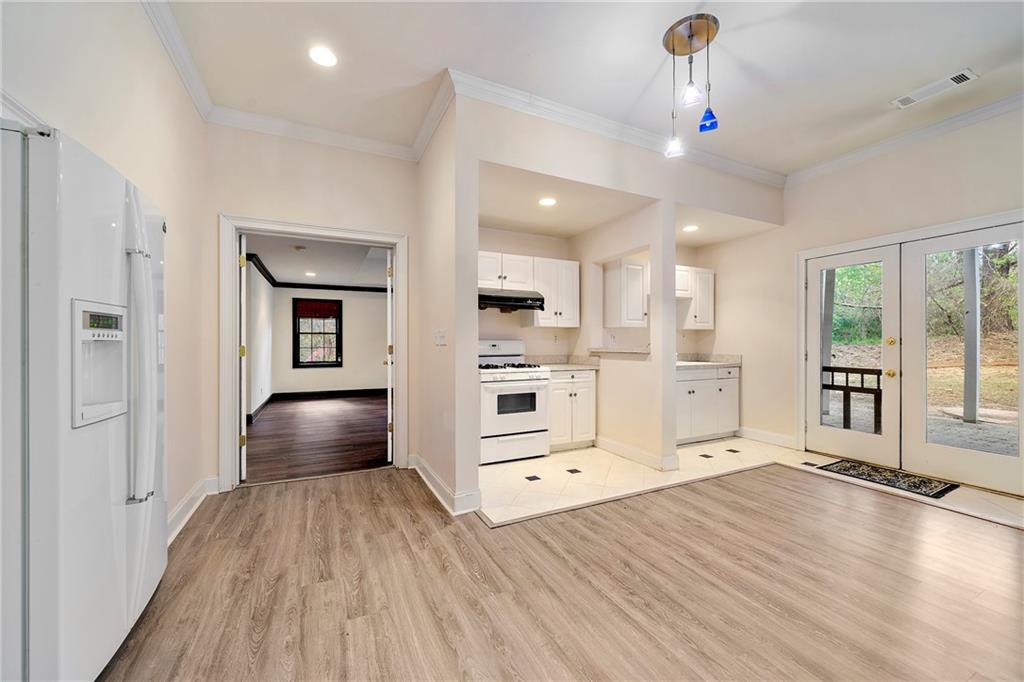 5360 Northwater Way Duluth, GA 30097 - Photo 41 of 62 a view of a kitchen with refrigerator and wooden floor