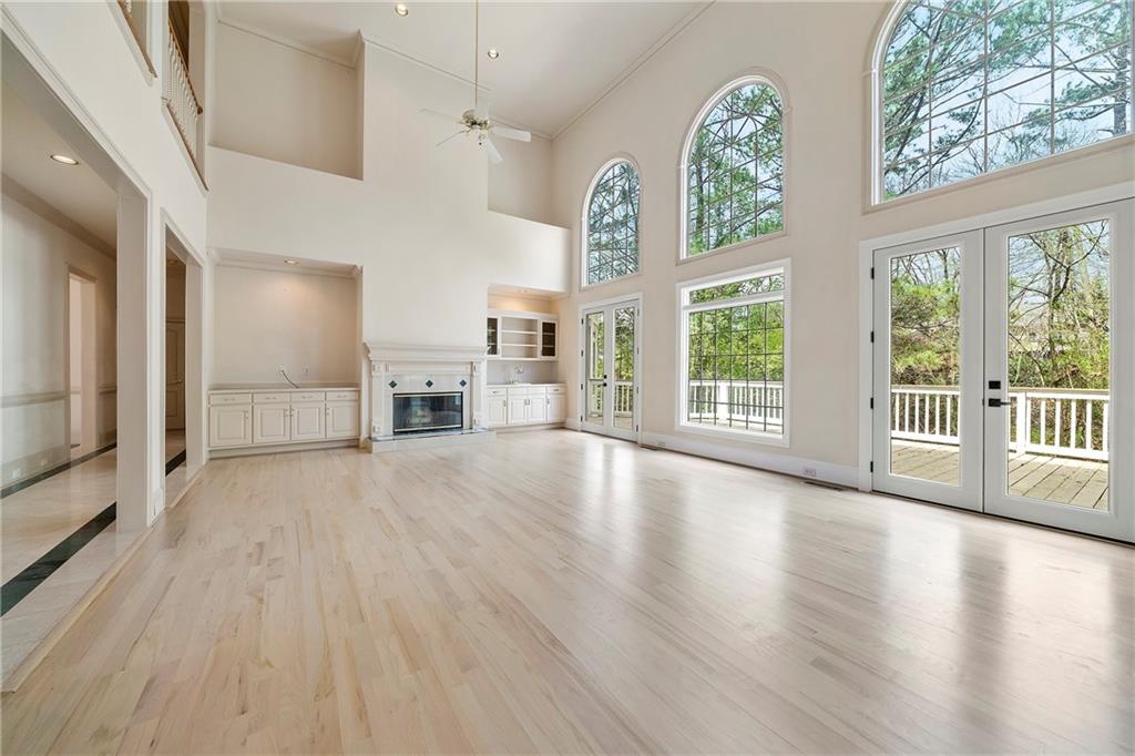 5360 Northwater Way Duluth, GA 30097 - Photo 8 of 62 wooden floor in an empty room with a fireplace and a window
