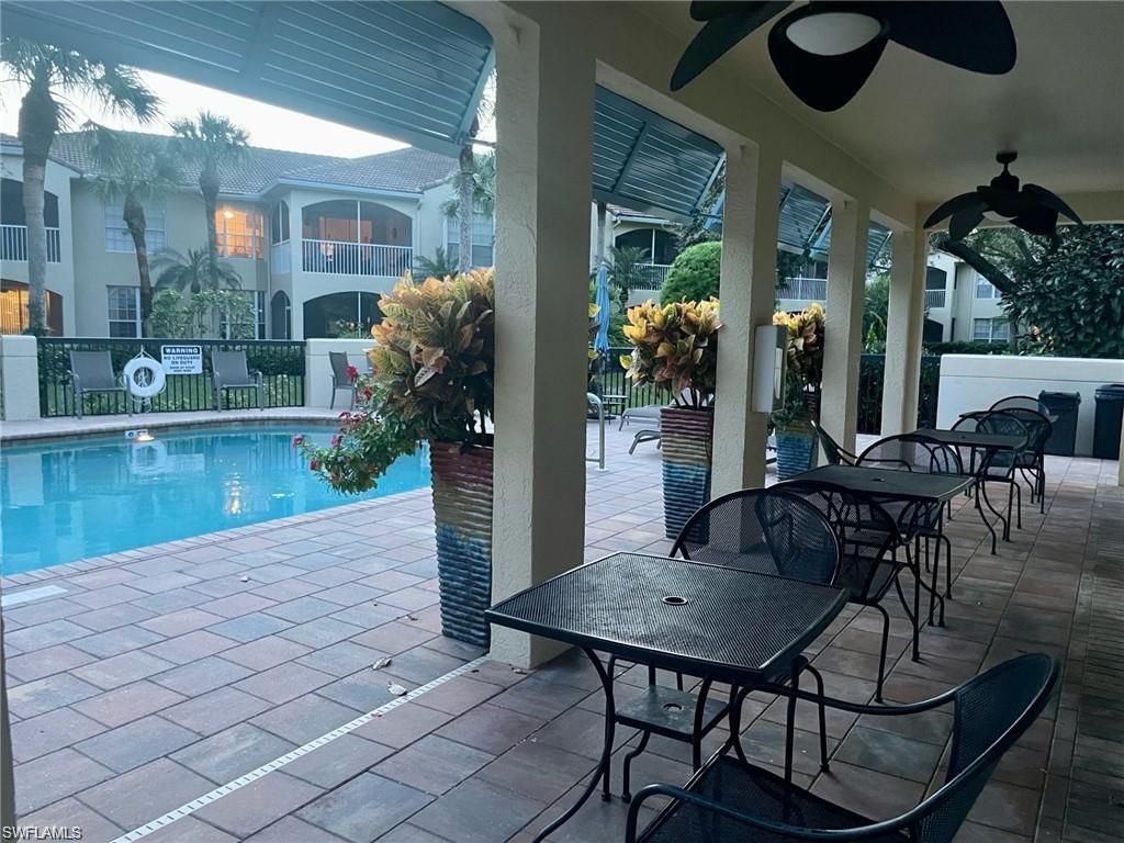 56 Silver Oaks Circle, Unit 102 Naples, FL 34119 - Photo 9 of 12 Community pool with a patio and ceiling fan