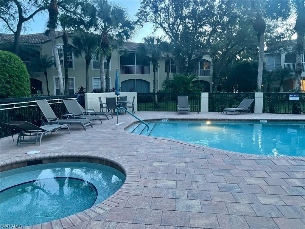 56 Silver Oaks Circle, Unit 102 Naples, FL 34119 - Photo 10 of 12 Community pool featuring a patio and a community hot tub