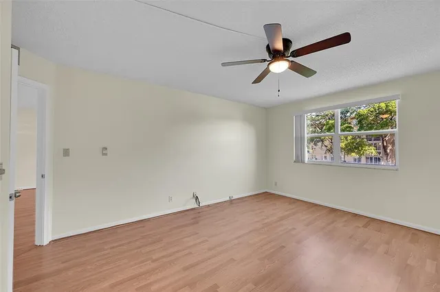 a view of a livingroom with a ceiling fan and window