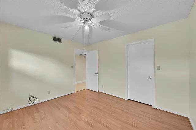 a view of a house with a yard and potted plants