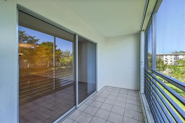 a room with lots of wooden furniture and a floor to ceiling window