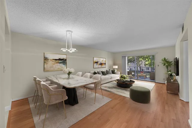 a living room with furniture a table and a potted plant