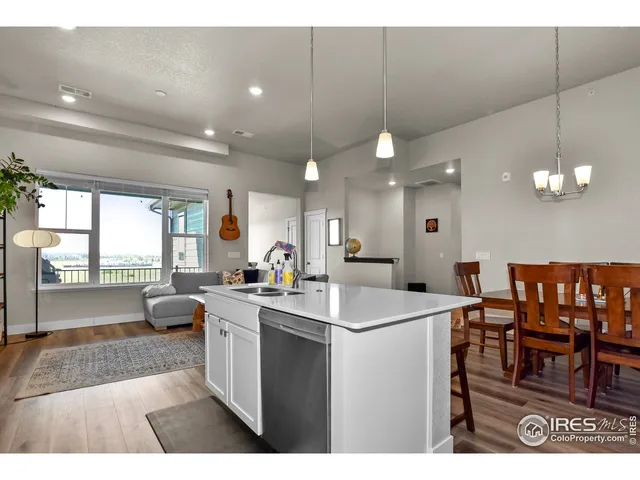 a kitchen with a dining table chairs and white cabinets