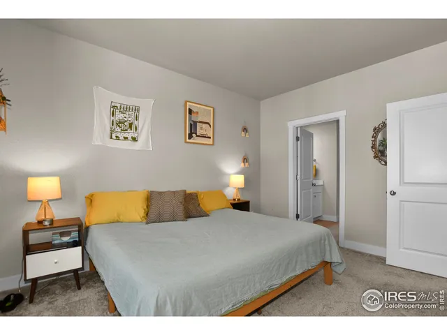 a bedroom with a bed and a lamp