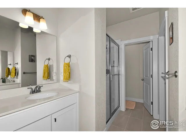 a bathroom with a sink a light fixture and a mirror