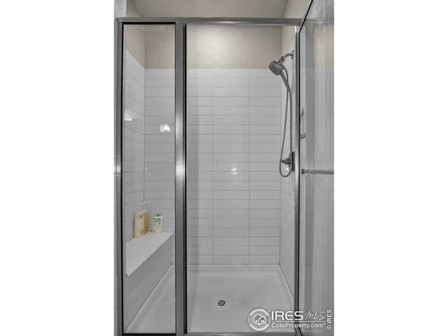 a bathroom with a glass shower door