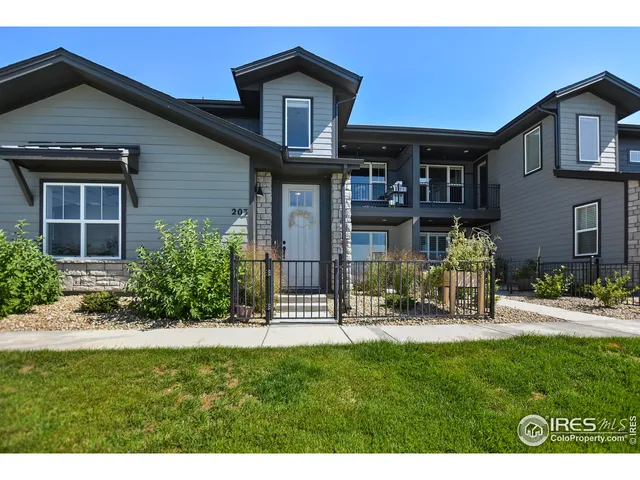 a front view of a house with porch and garden
