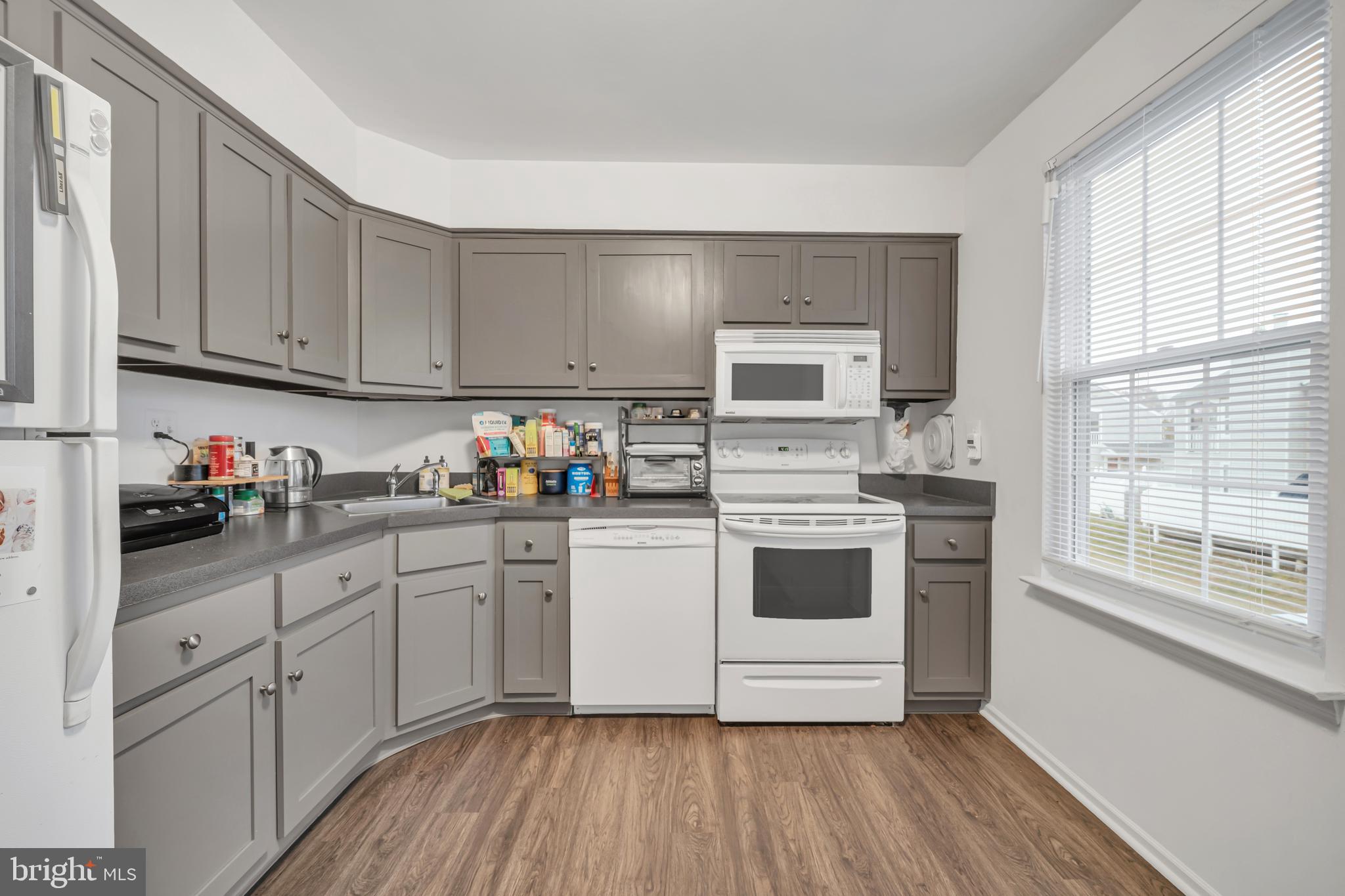 604 Wrensong Road Yardley, PA 19067 - Photo 13 of 37 a kitchen with granite countertop white cabinets and white appliances