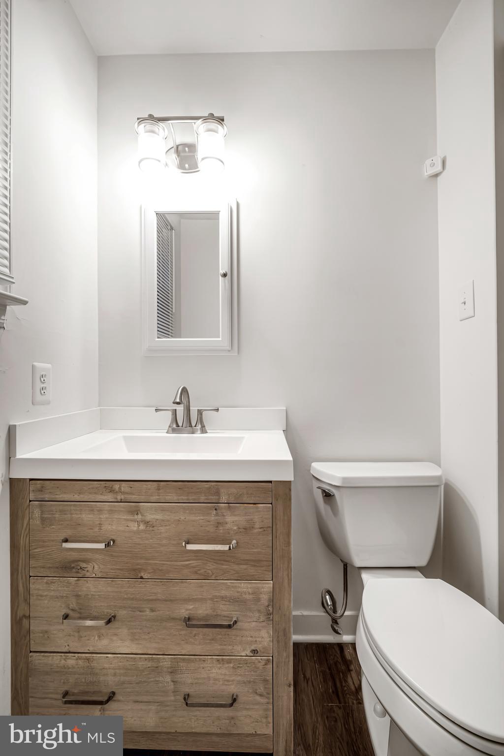 604 Wrensong Road Yardley, PA 19067 - Photo 19 of 37 a bathroom with a granite countertop toilet sink mirror and vanity