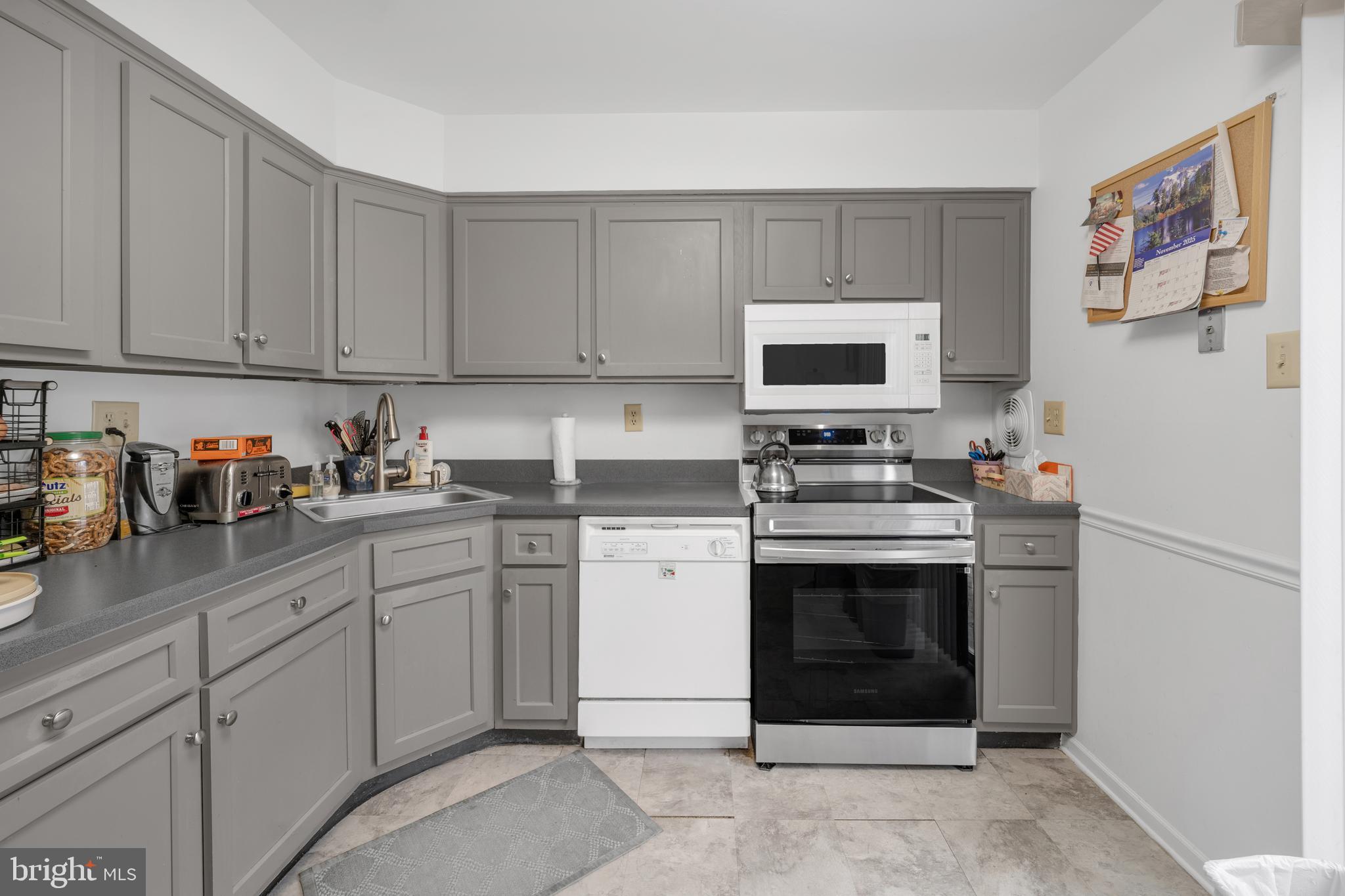 604 Wrensong Road Yardley, PA 19067 - Photo 29 of 37 a kitchen with stainless steel appliances granite countertop a stove a sink and a refrigerator