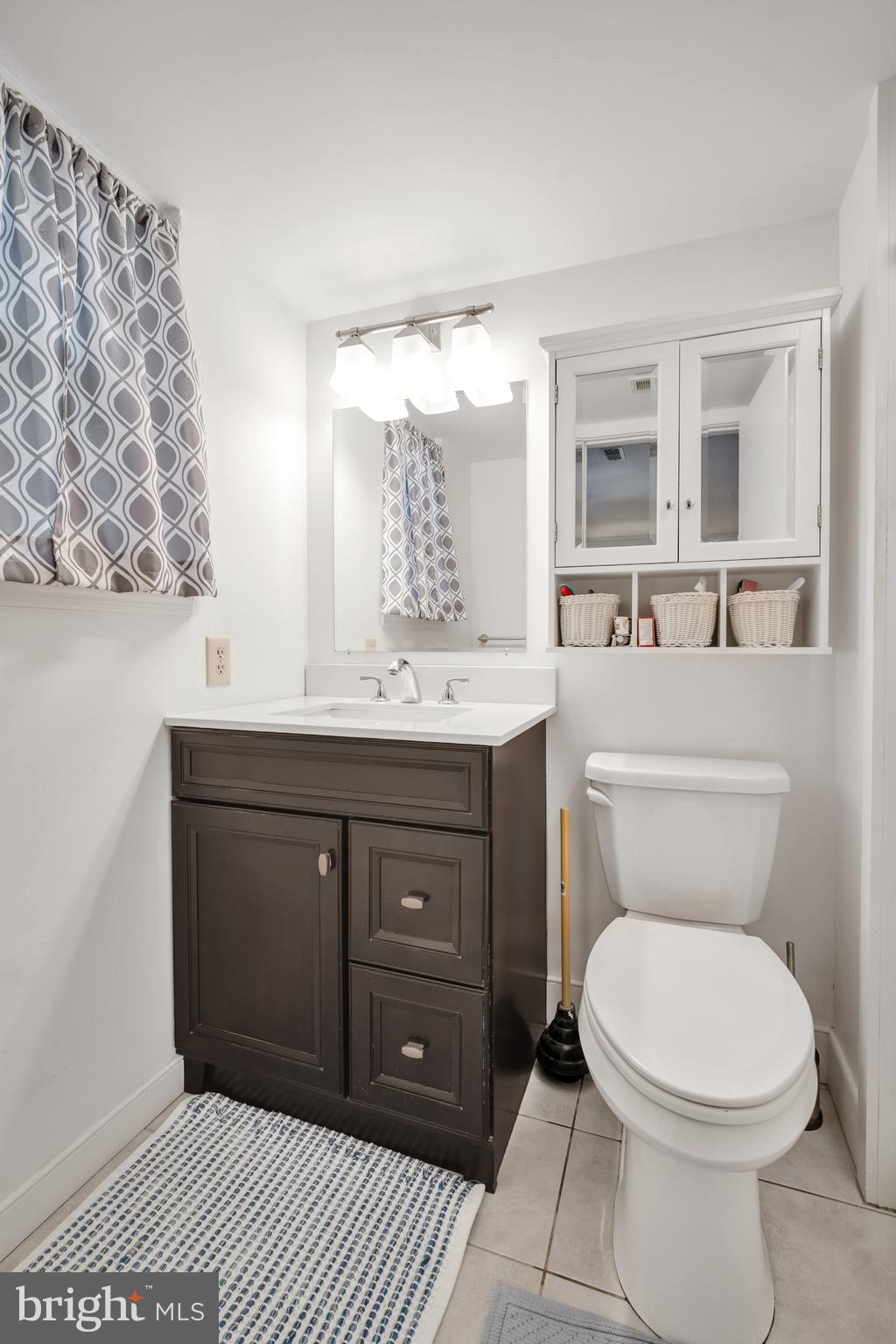 604 Wrensong Road Yardley, PA 19067 - Photo 34 of 37 a bathroom with a toilet a sink and mirror