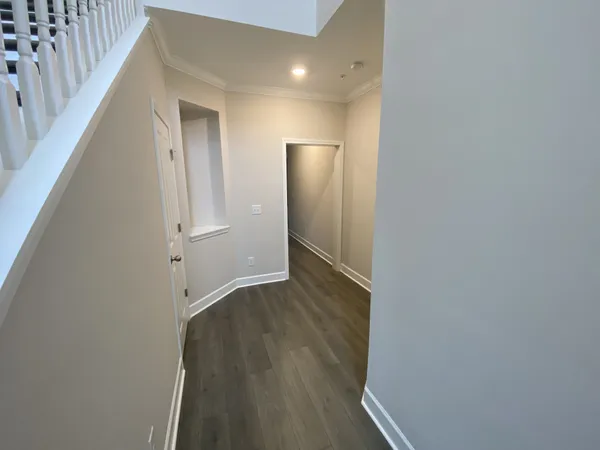 a view of hallway with wooden floor