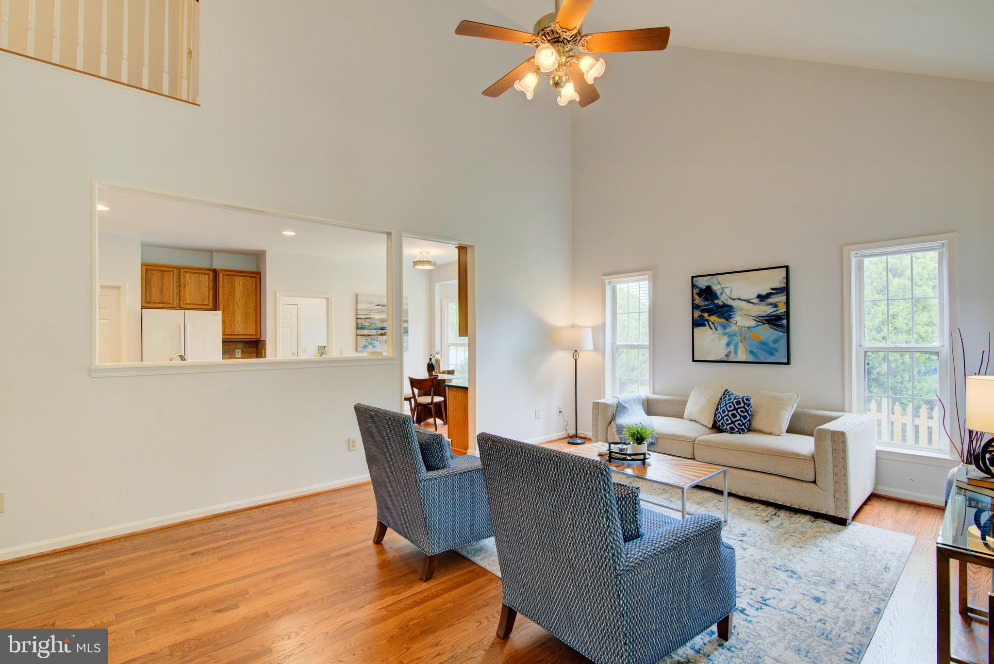 12719 Hitchcock Court Reston, VA 20191 - Photo 11 of 55 a living room with furniture chandelier and a window