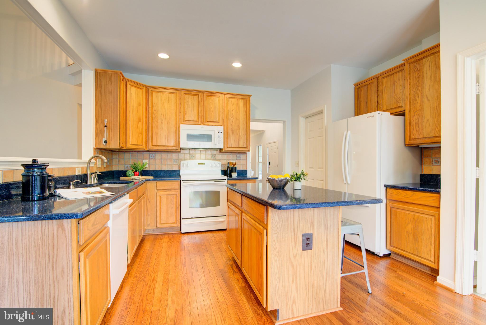 12719 Hitchcock Court Reston, VA 20191 - Photo 15 of 55 a kitchen with stainless steel appliances granite countertop a sink stove and refrigerator