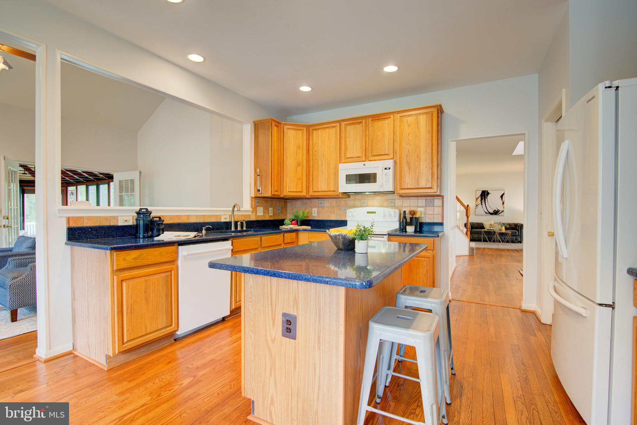 12719 Hitchcock Court Reston, VA 20191 - Photo 16 of 55 a kitchen with stainless steel appliances granite countertop a refrigerator a stove and a sink with cabinets