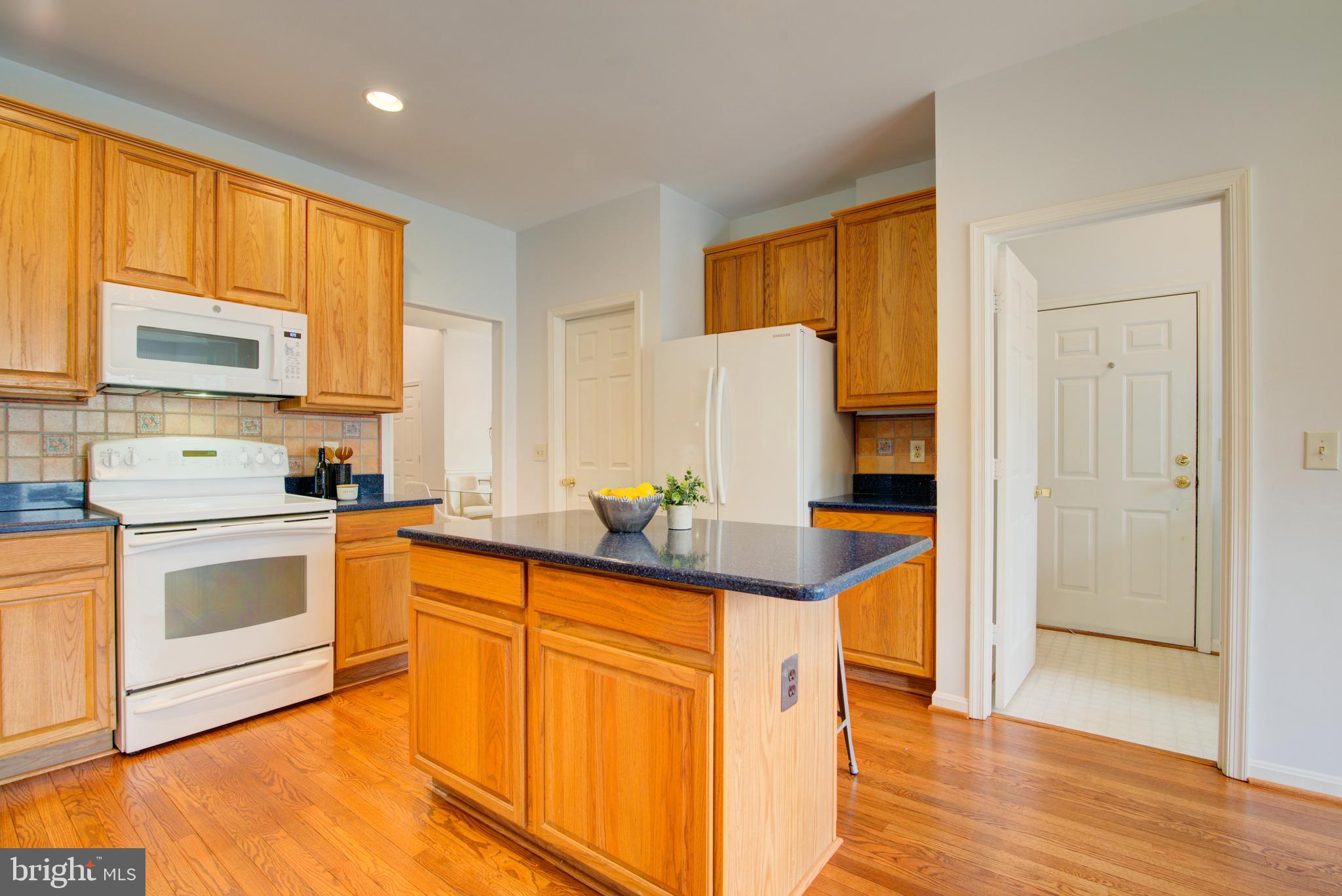 12719 Hitchcock Court Reston, VA 20191 - Photo 18 of 55 a kitchen with stainless steel appliances granite countertop a stove a sink and a refrigerator