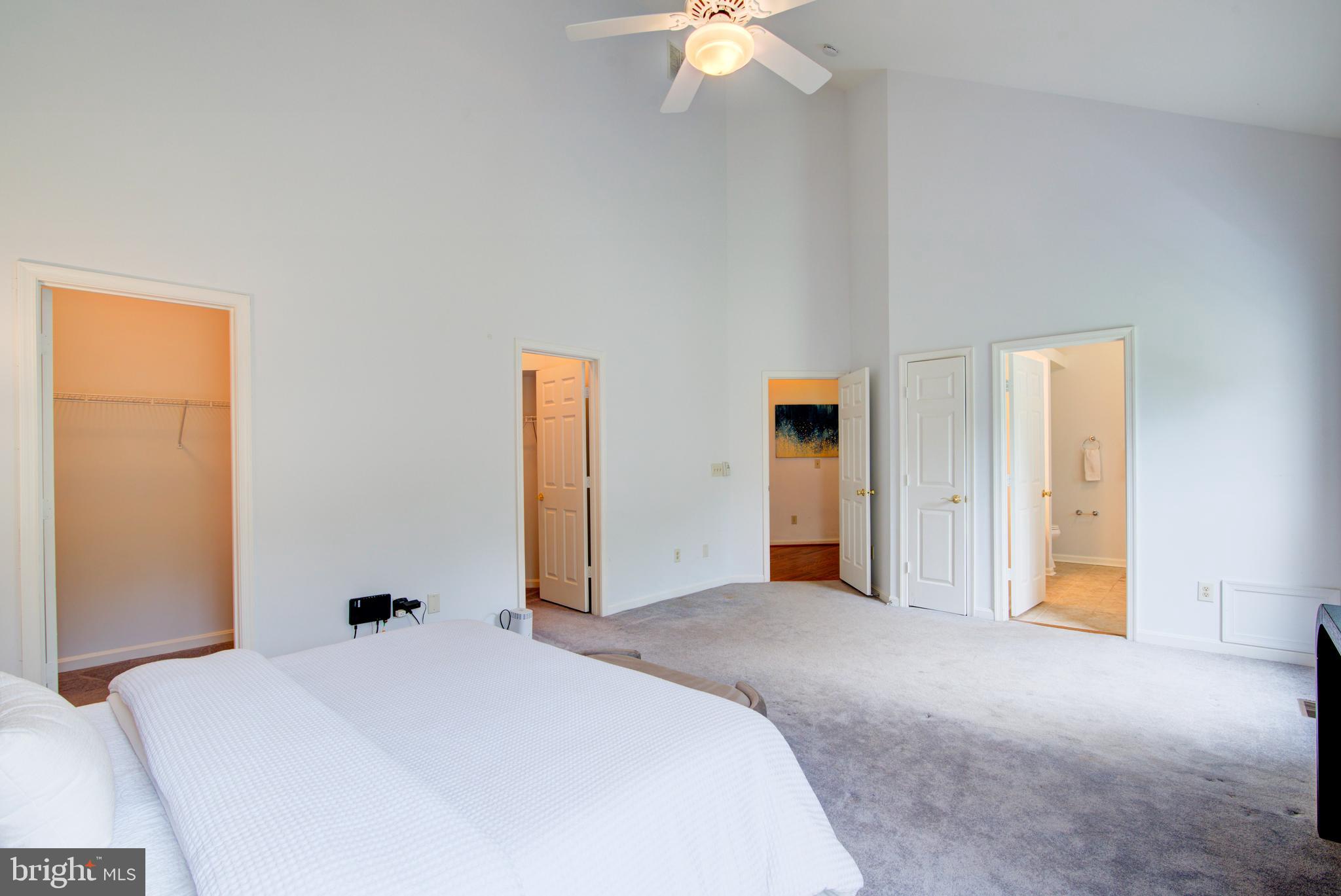 12719 Hitchcock Court Reston, VA 20191 - Photo 25 of 55 a bedroom with a bed and a chandelier