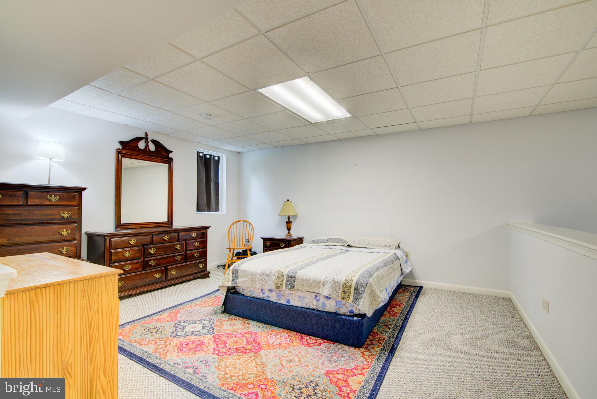 12719 Hitchcock Court Reston, VA 20191 - Photo 40 of 55 a bedroom with a bed and dresser with mirror