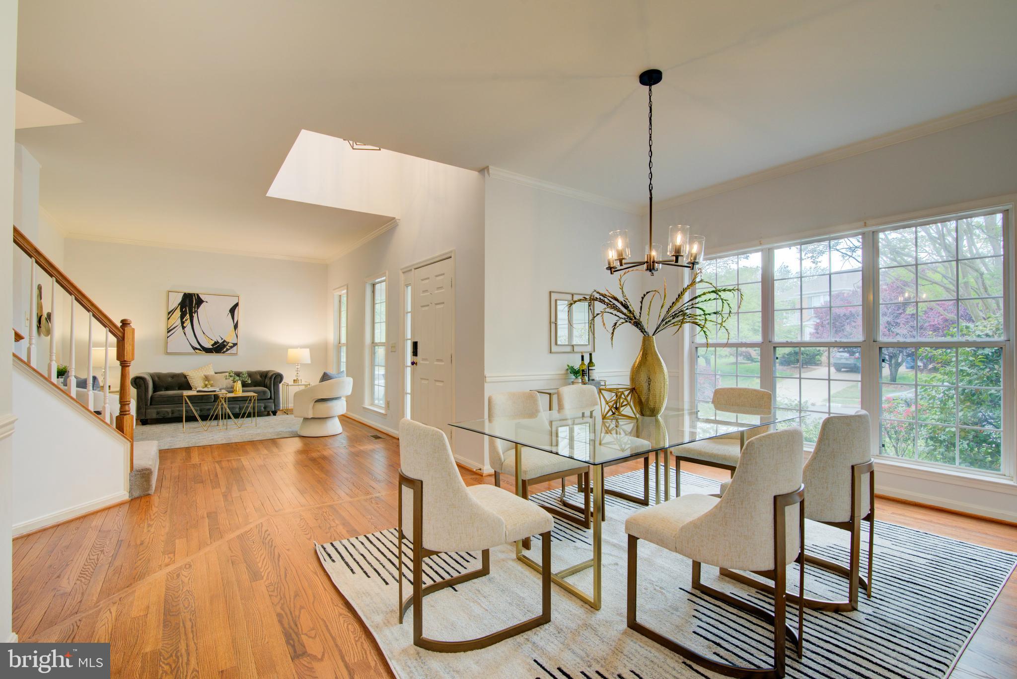 12719 Hitchcock Court Reston, VA 20191 - Photo 5 of 55 a view of a dining room with furniture wooden floor and a chandelier