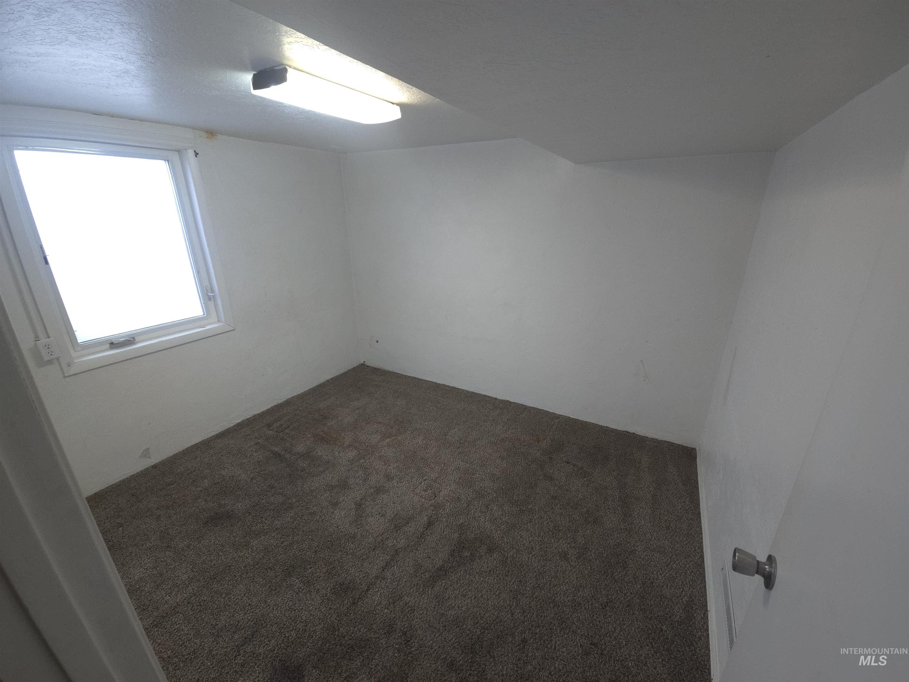 458 Rose Street North Twin Falls, ID 83301 - Photo 12 of 17 Empty room with dark carpet