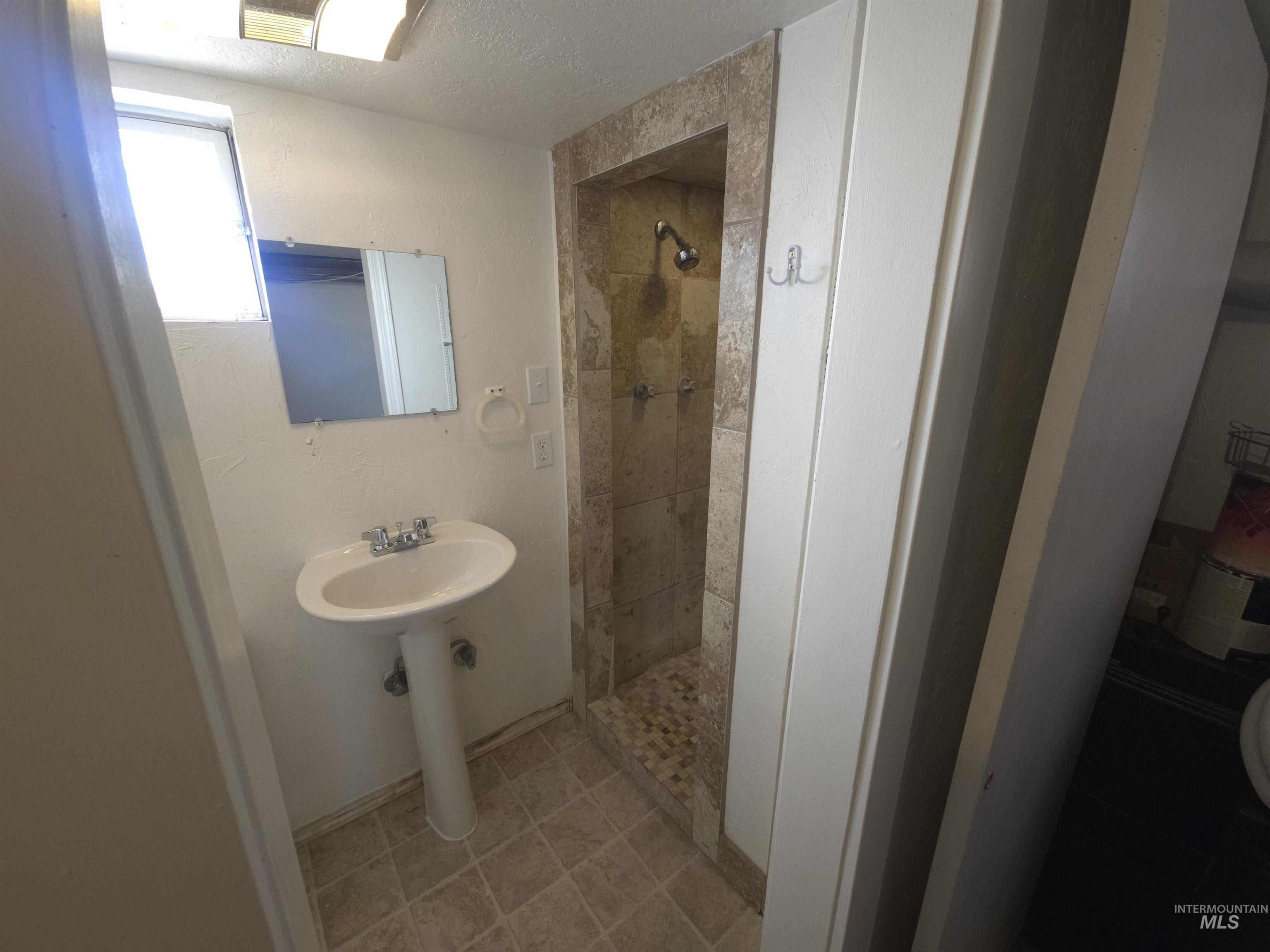 458 Rose Street North Twin Falls, ID 83301 - Photo 14 of 17 Bathroom featuring a stall shower and a textured ceiling