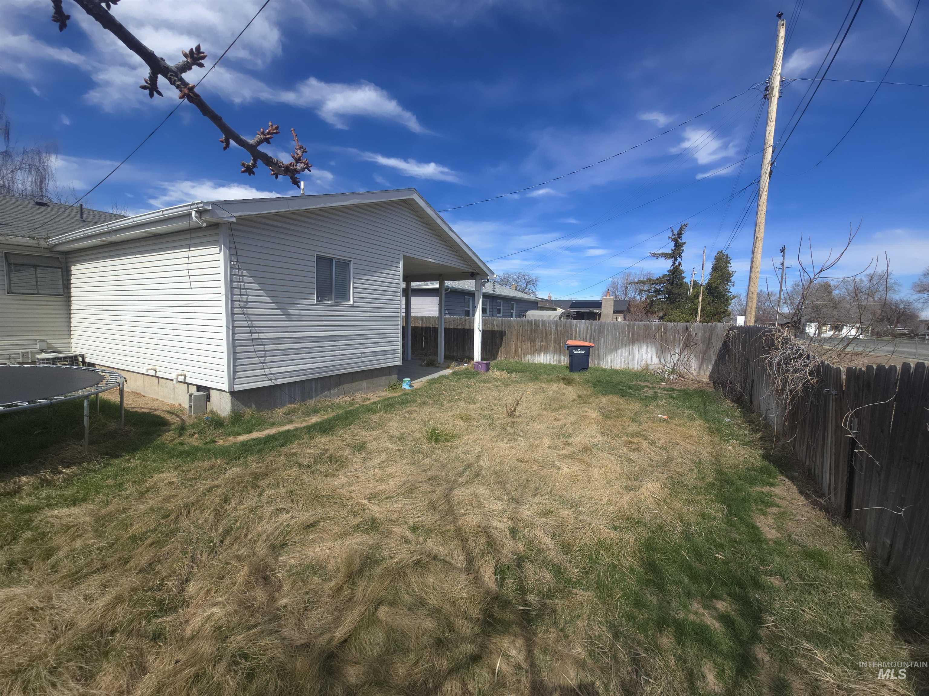 458 Rose Street North Twin Falls, ID 83301 - Photo 17 of 17 Fenced backyard featuring a trampoline and a patio