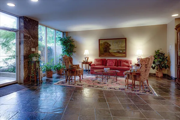 a living room with furniture a window and a dining table