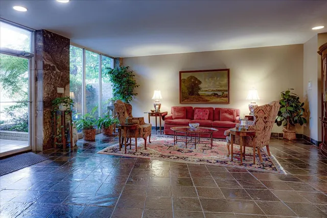 a living room with furniture a window and a dining table
