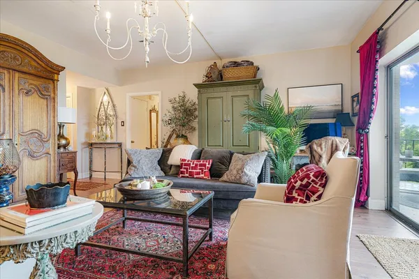 a living room with furniture and a chandelier