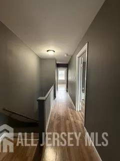 a view of hallway with wooden floor