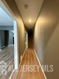 a view of a room with wooden floor