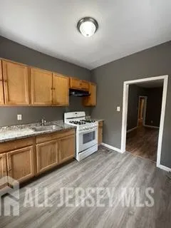 a kitchen with stainless steel appliances granite countertop a sink and a stove