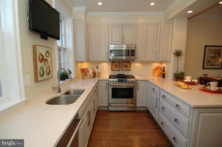 3318 R Street Northwest Washington, DC 20007 - Photo 15 of 26 a kitchen with stainless steel appliances a stove a sink a microwave and cabinets