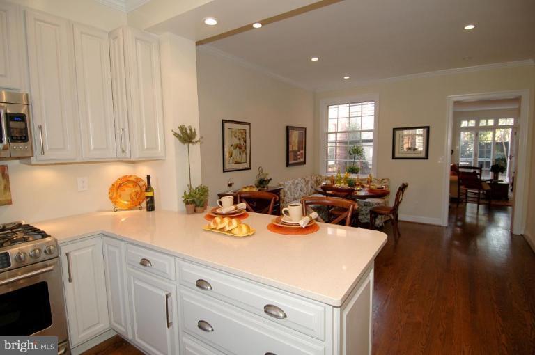 3318 R Street Northwest Washington, DC 20007 - Photo 16 of 26 a view of a kitchen with dining table and chairs