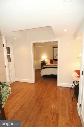 3318 R Street Northwest Washington, DC 20007 - Photo 20 of 26 a view of a bedroom with a bed and wooden floor
