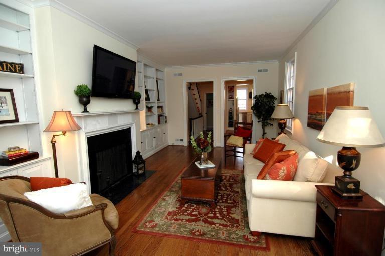 3318 R Street Northwest Washington, DC 20007 - Photo 5 of 26 a living room with furniture a flat screen tv and a fireplace