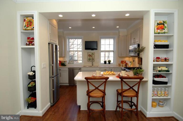 3318 R Street Northwest Washington, DC 20007 - Photo 6 of 26 a kitchen with stainless steel appliances granite countertop a refrigerator and a dining table
