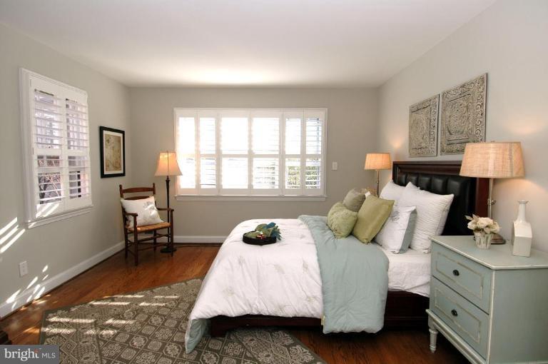 3318 R Street Northwest Washington, DC 20007 - Photo 10 of 26 a bedroom with a bed wooden floor and window