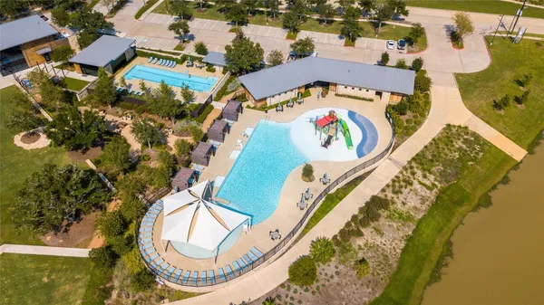 an aerial view of a house with a yard and a fountain