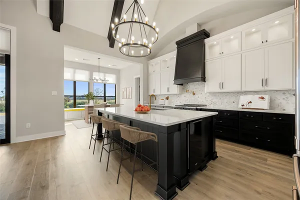 a kitchen with stainless steel appliances granite countertop a stove and cabinets