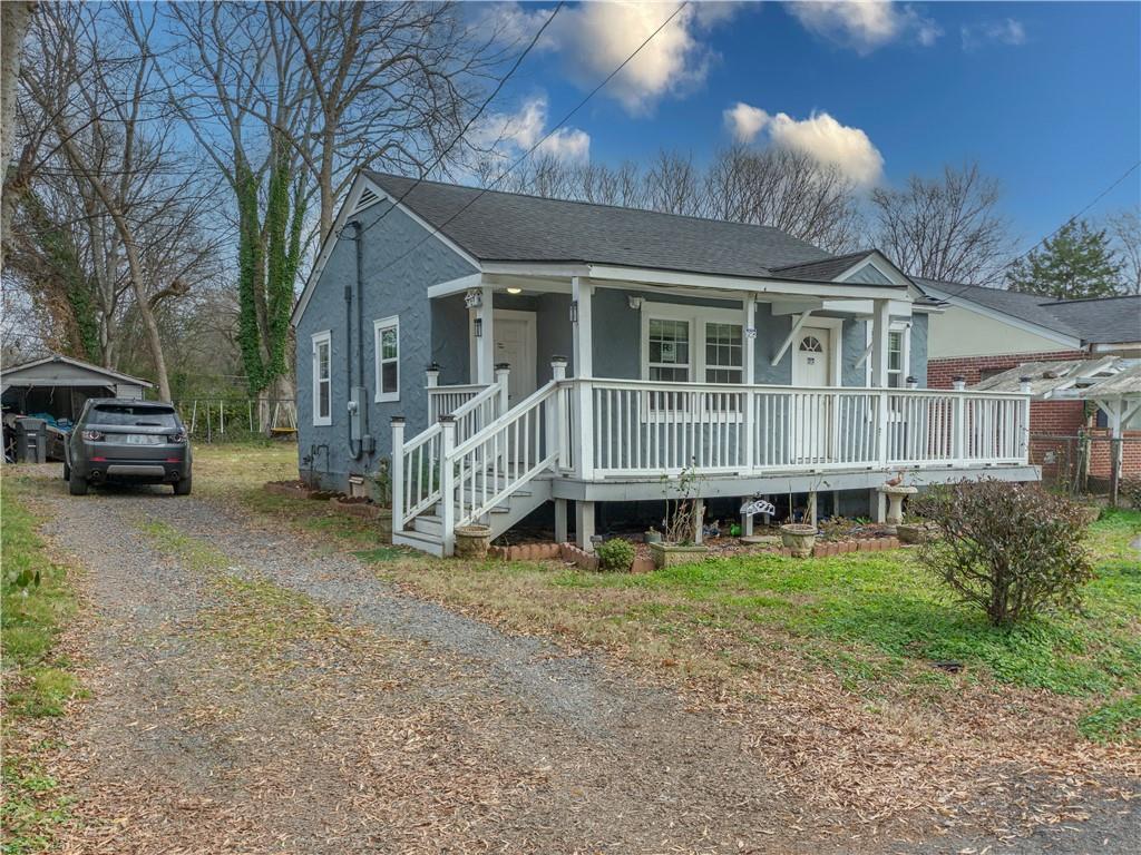 a view of a house with a yard and sitting area