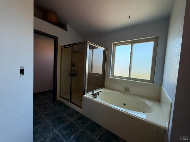 a bathroom with a bathtub and a shower