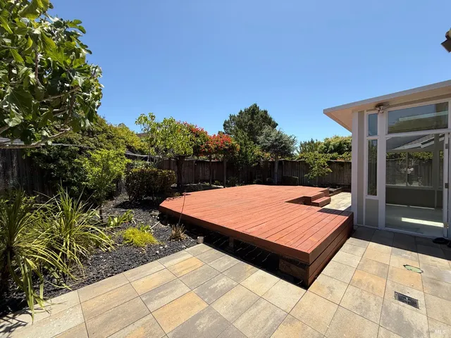 a wooden bench sitting in front of a building