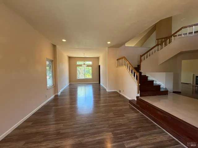 a view of entryway and hall with wooden floor